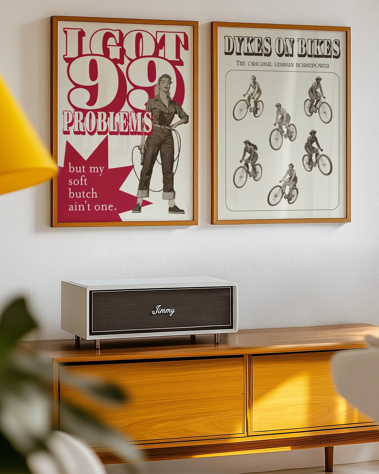 A framed poster depicting a soft butch wearing jeans and a shirt, holding a drill with the text: “I GOT 99 PROBLEMS” and “but my soft butch ain't one.”