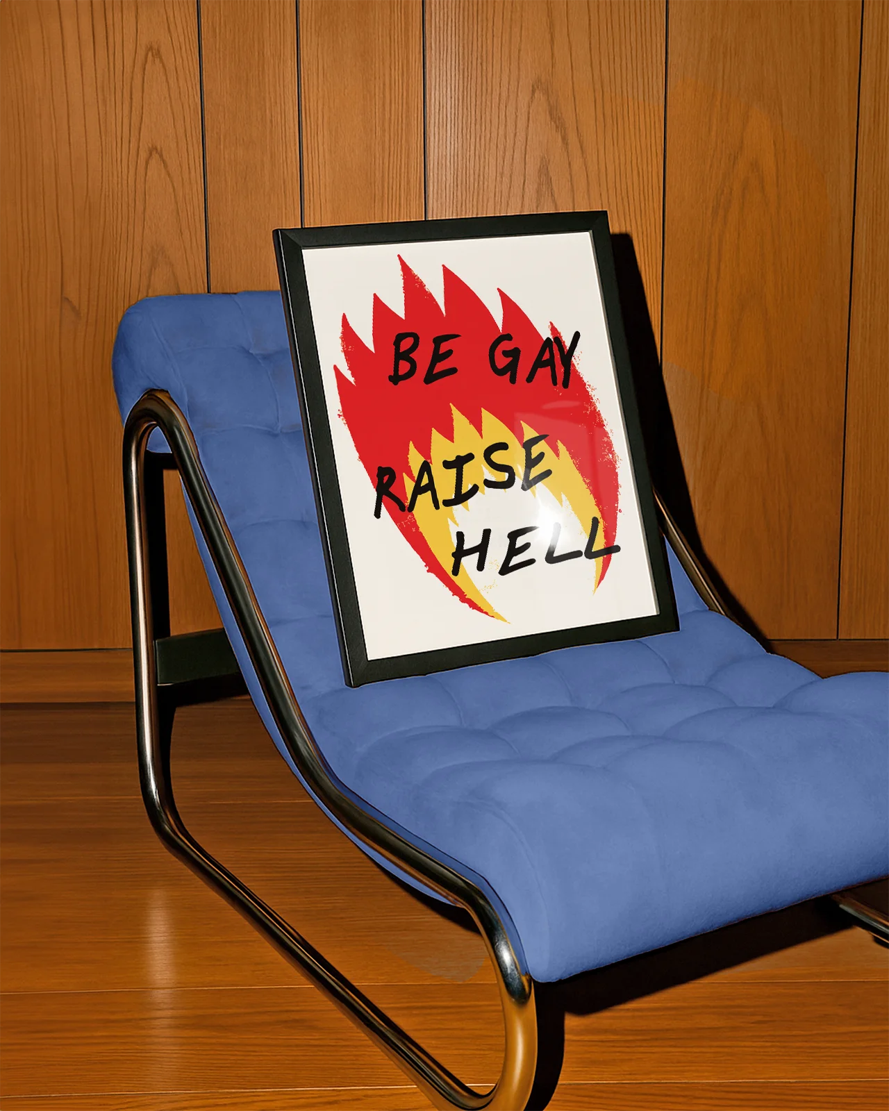A poster with an illustrated flame, with the text 'BE GAY RAISE HELL'.
