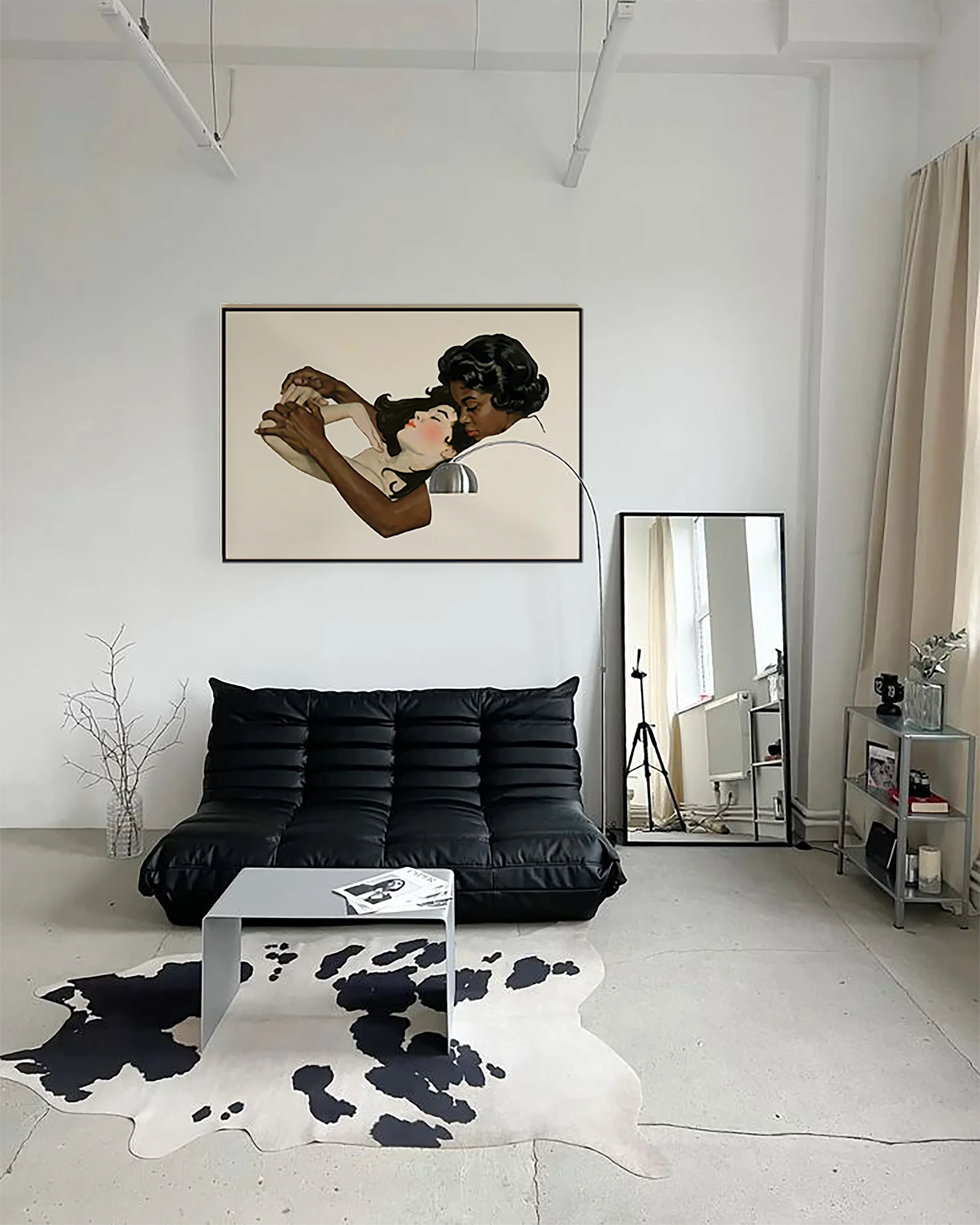 A framed, horizontal print with two lesbian women in a warm, romantic embrace.