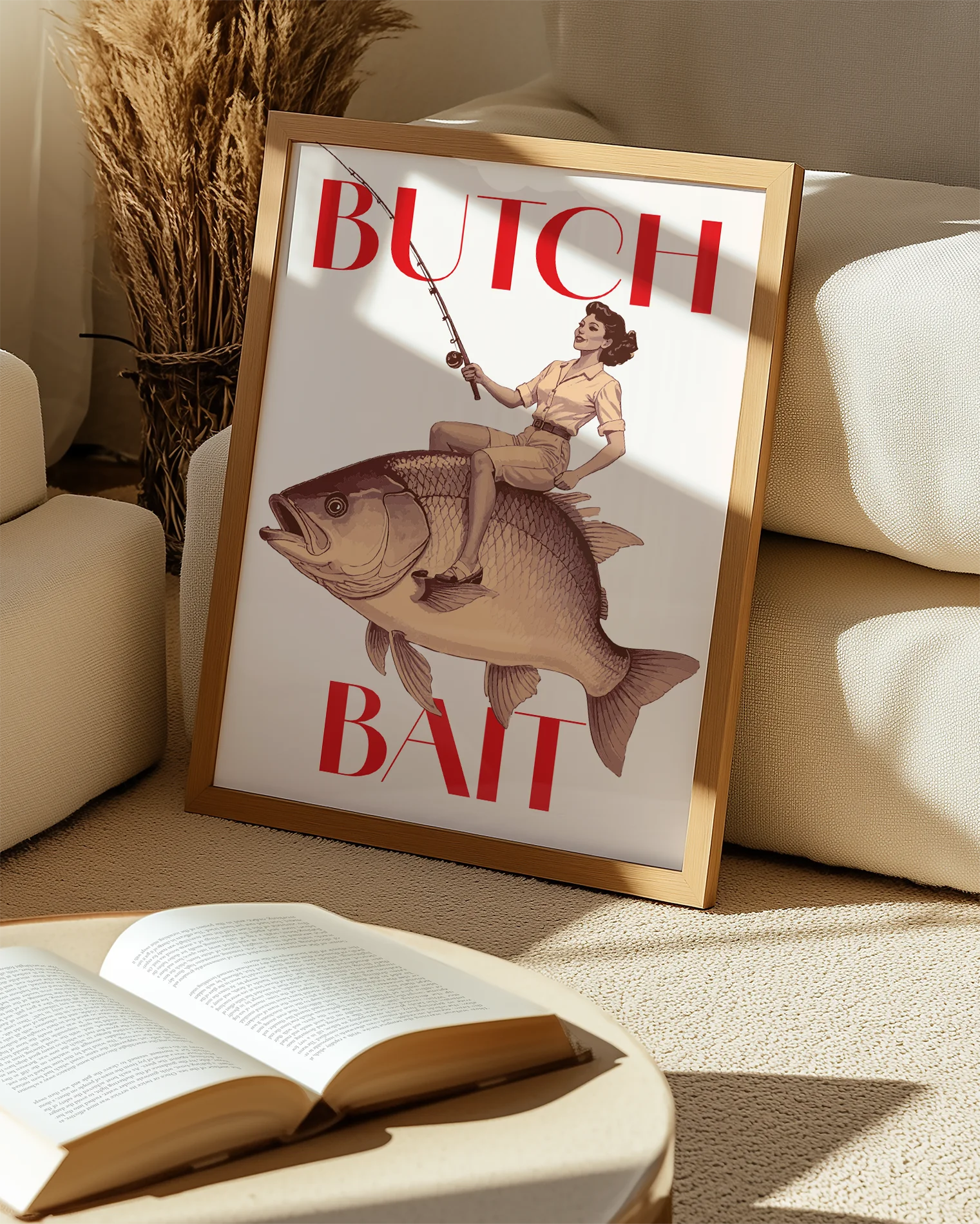 A poster depicting a lesbian woman riding a fish and holding a fishing rod, with the text ‘BUTCH BAIT'.
