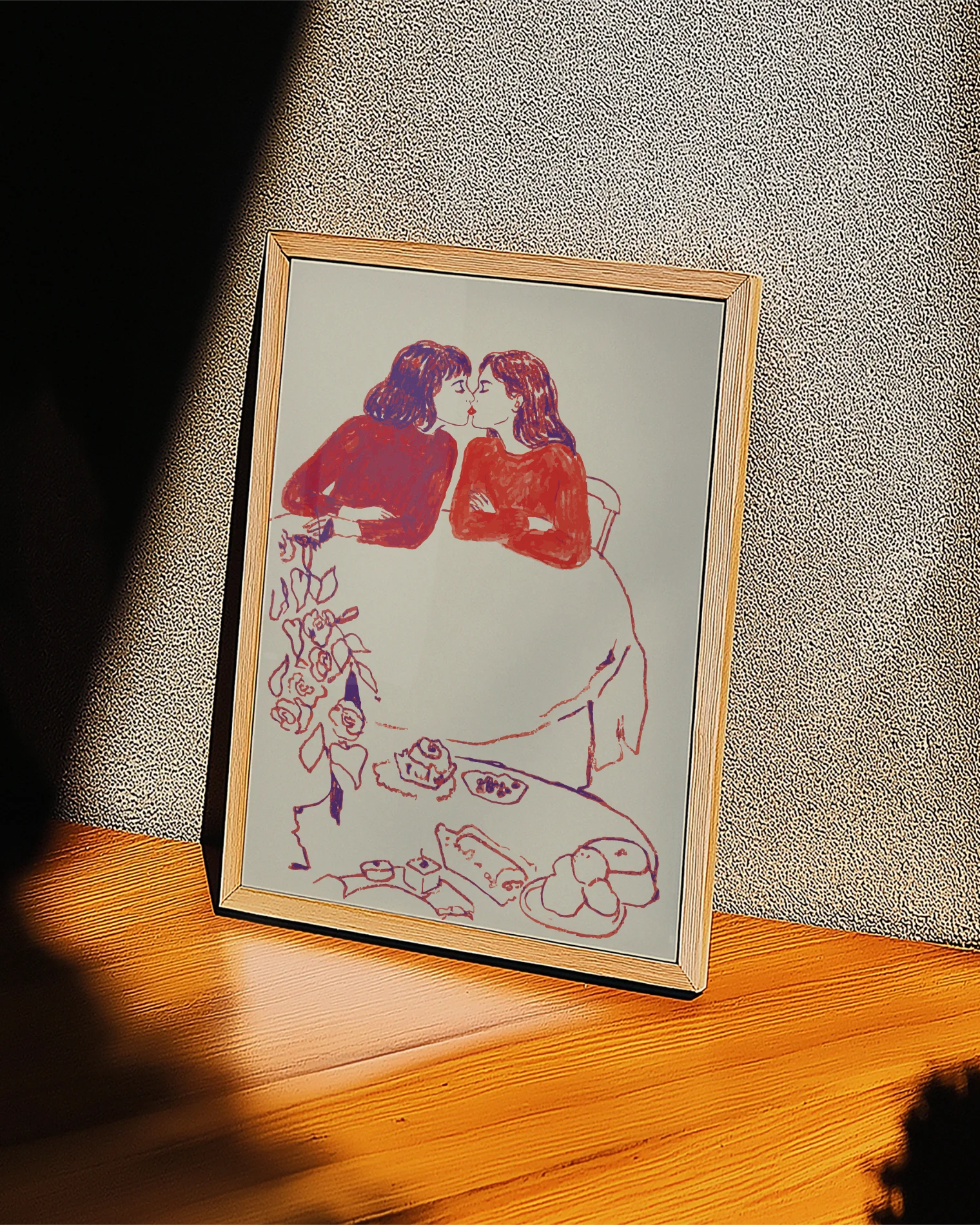 A framed poster with a sketched, lesbian cute couple kissing at a café.