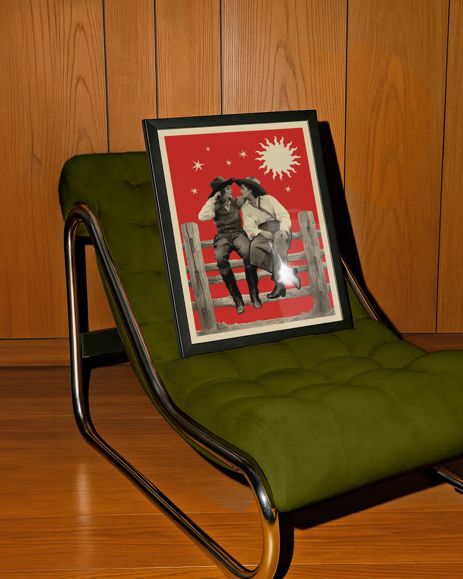 A framed poster with two lesbian cowgirls, sitting on a wooden fence, talking and flirting.