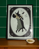 A poster with a lesbian witch couple kissing.