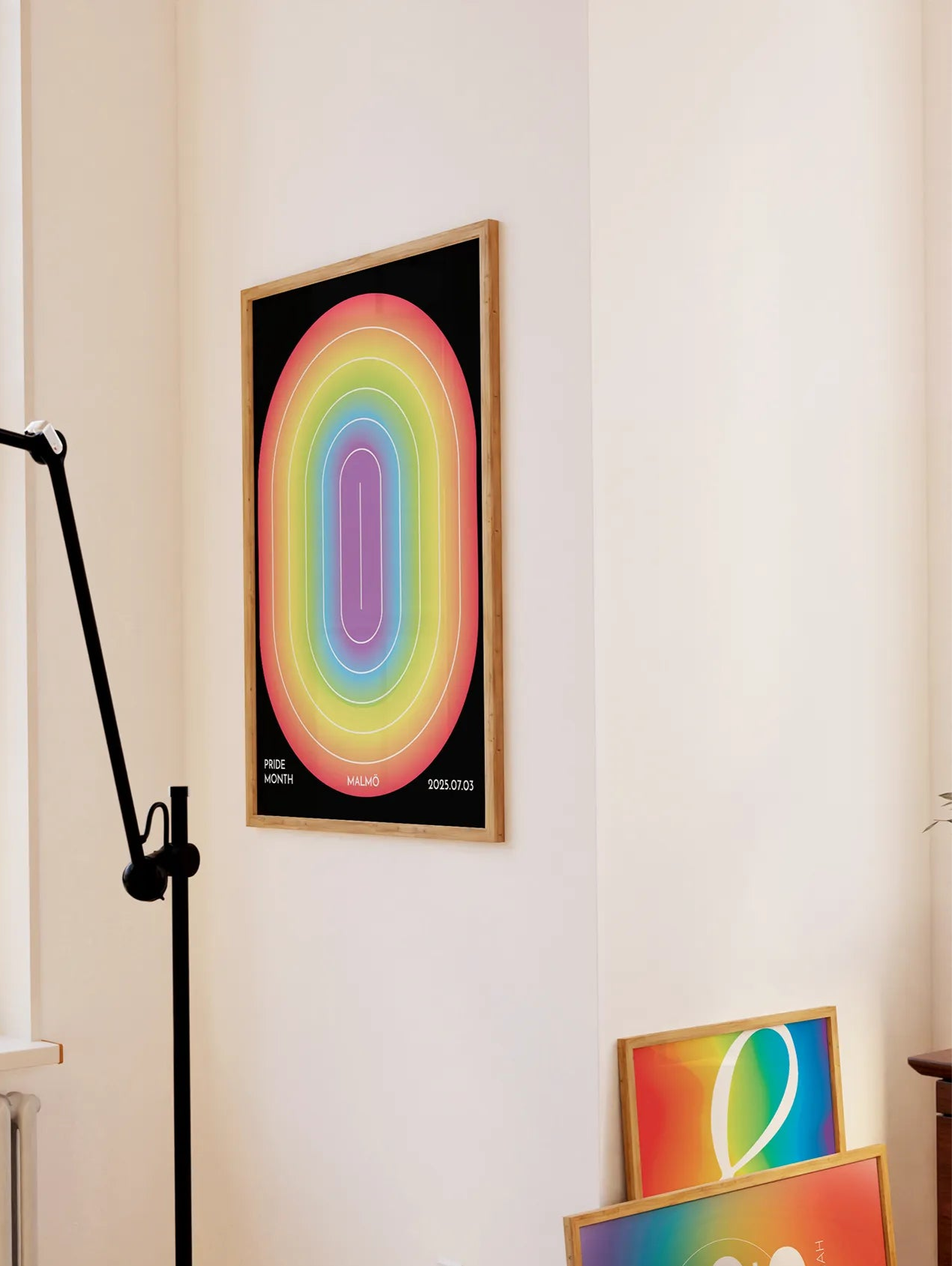 Three posters with pridetheme on wall.