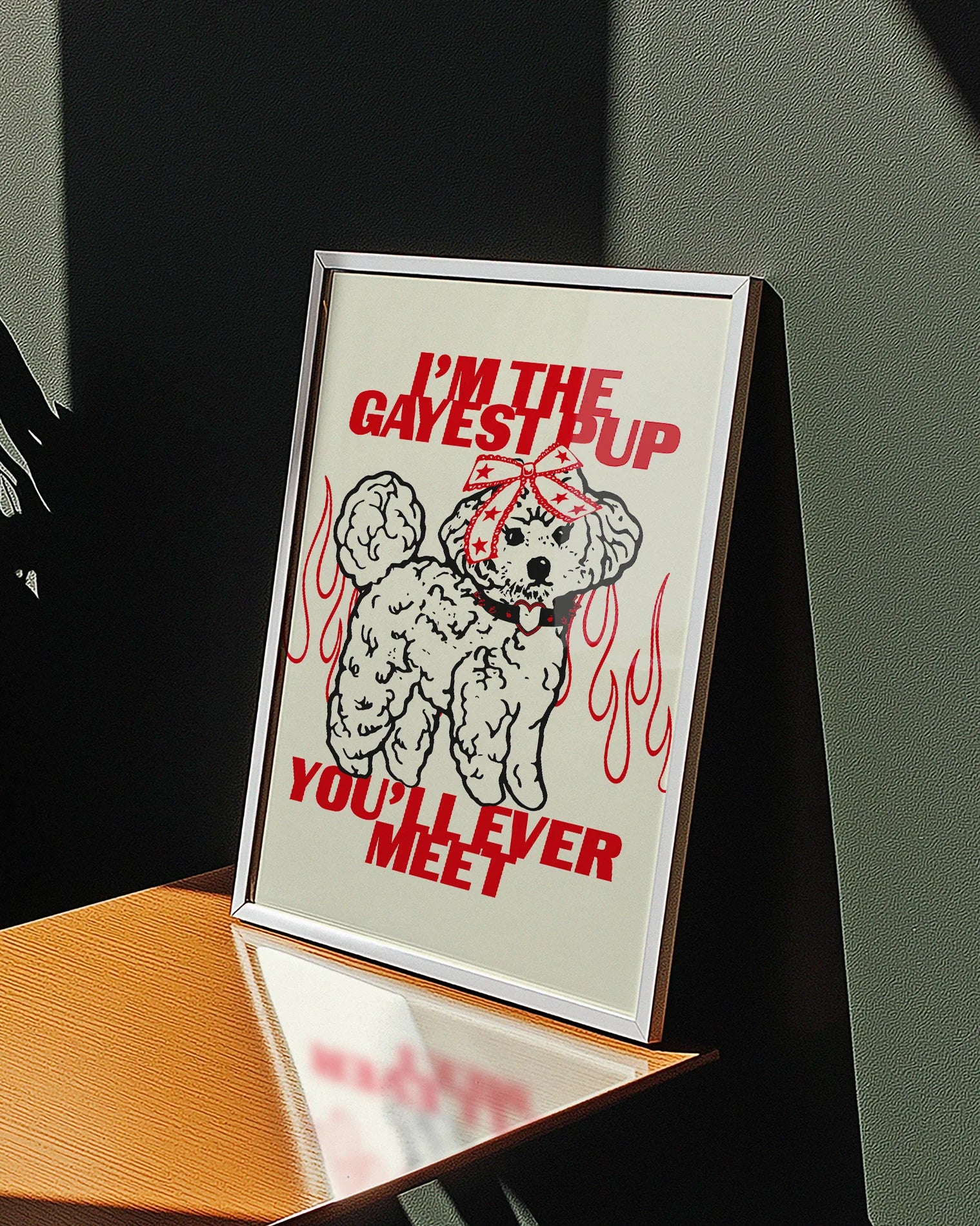A poster featuring an illustrated, adorable little poodle wearing a punk collar and a bowtie on it's head, with the text: ‘I'M THE GAYEST DOG YOU'LL EVER MEET.’