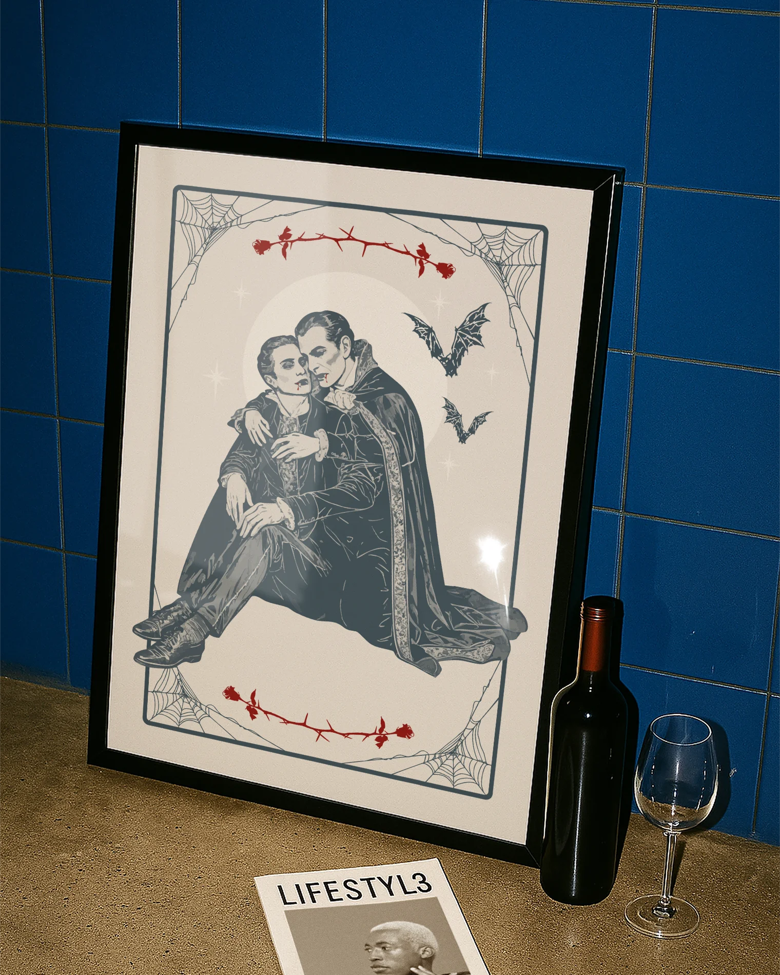 A poster depicting two male vampires embracing each other in a romantic hug, surrounded by a webbed frame, a large white moon, red roses, and flying bats.