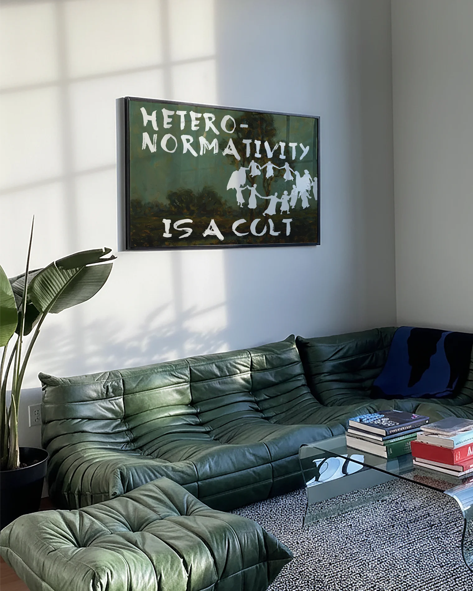A framed poster depicting a group of people dancing in a cult-like circle, accompanied by the text “Heteronormativity Is a Cult.”