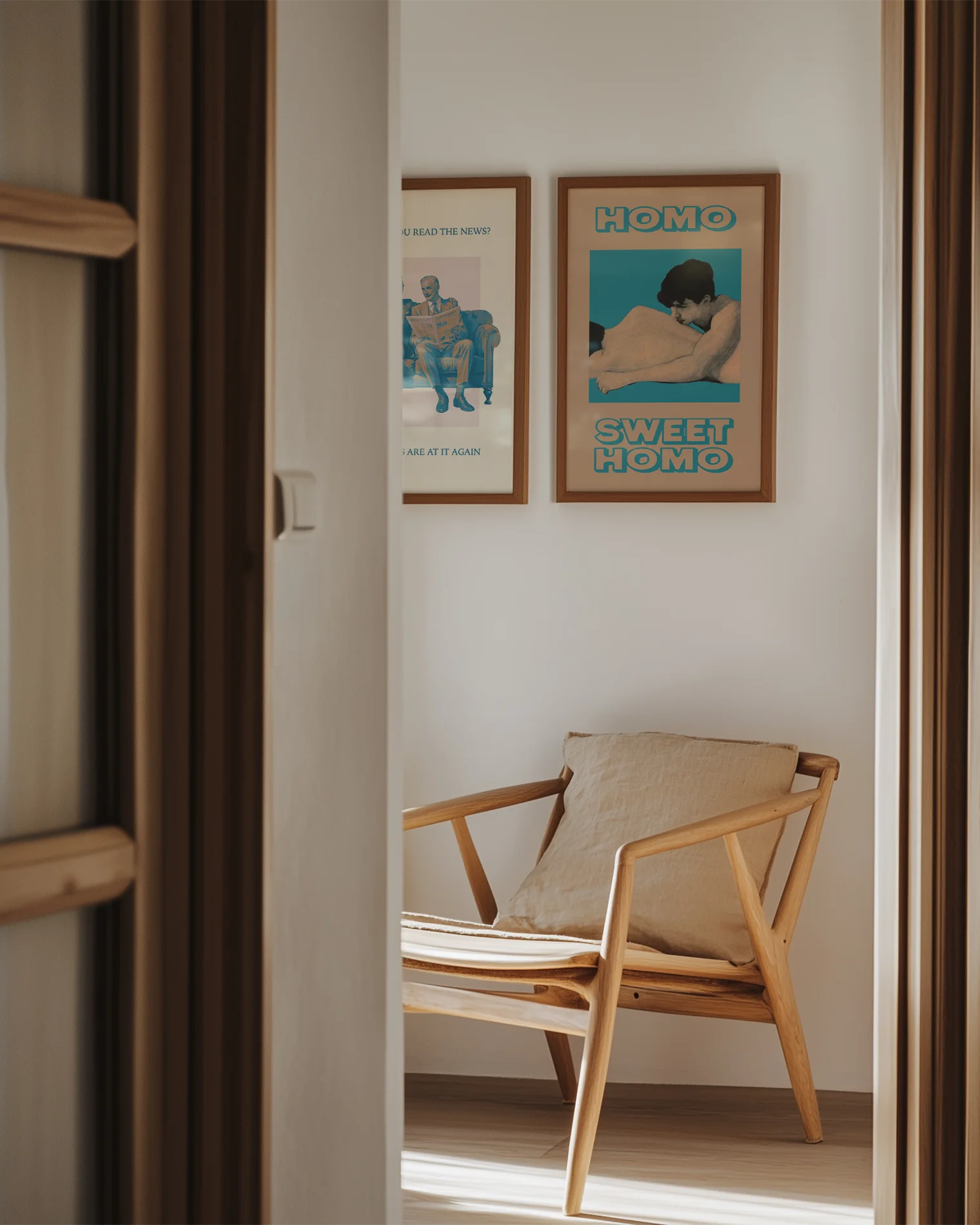 A framed poster featuring two naked men lying closely together in a soft and romantic pose, with the text: “HOMO SWEET HOMO.”