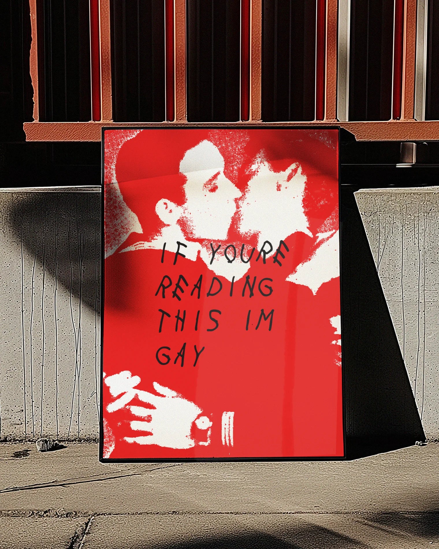 A poster with two illustrated men in uniforms kissing, with the text 'If you're reading this I'm gay'.