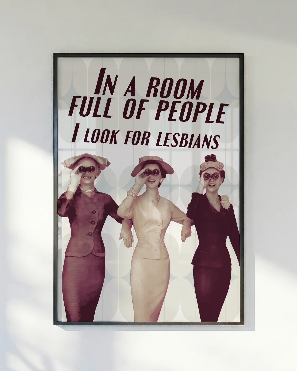 A poster with three ladies in vintage style holding binoculars with the text 'In a room full of people, I look for lesbians'.