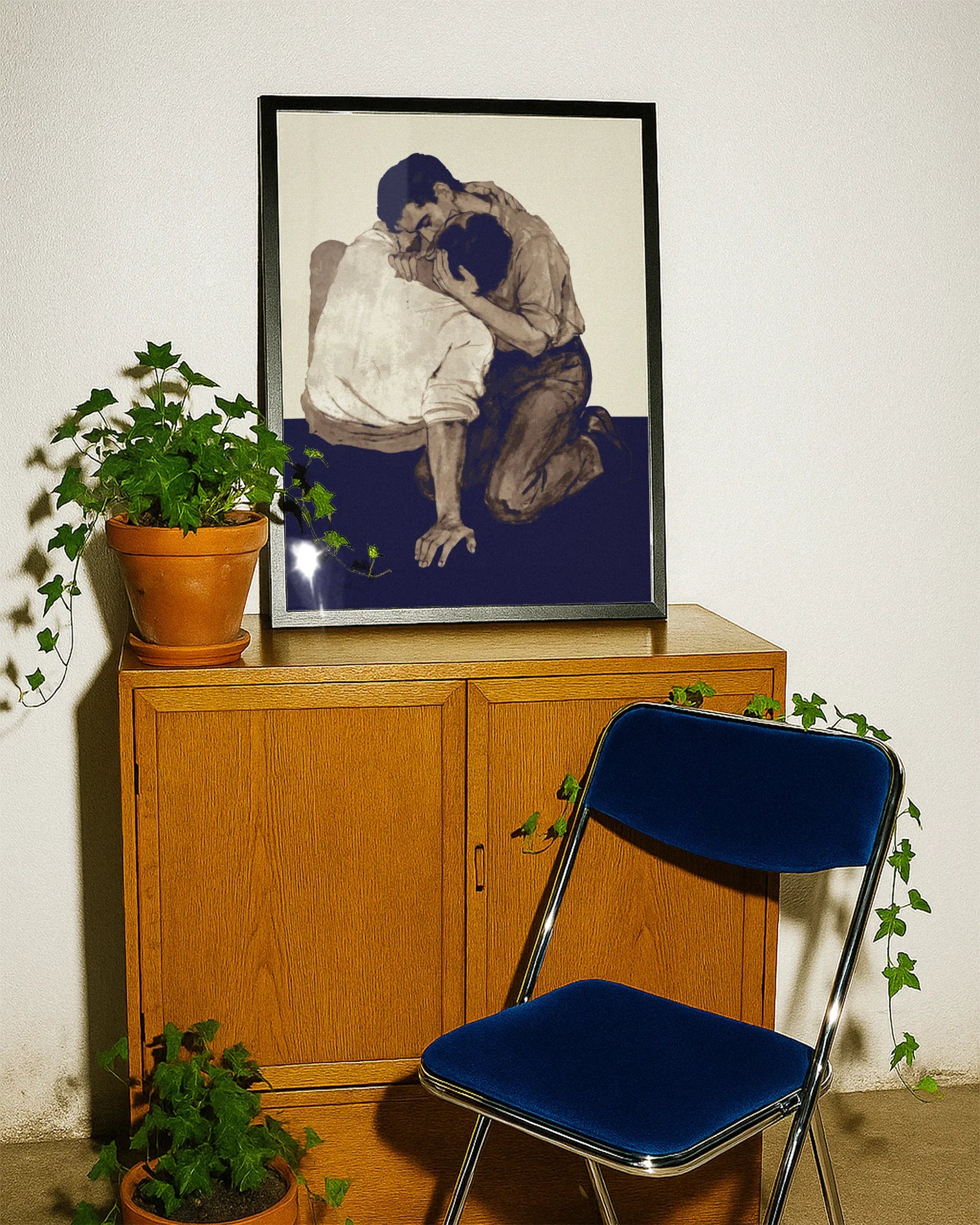 A poster with two men kissing on the floor.