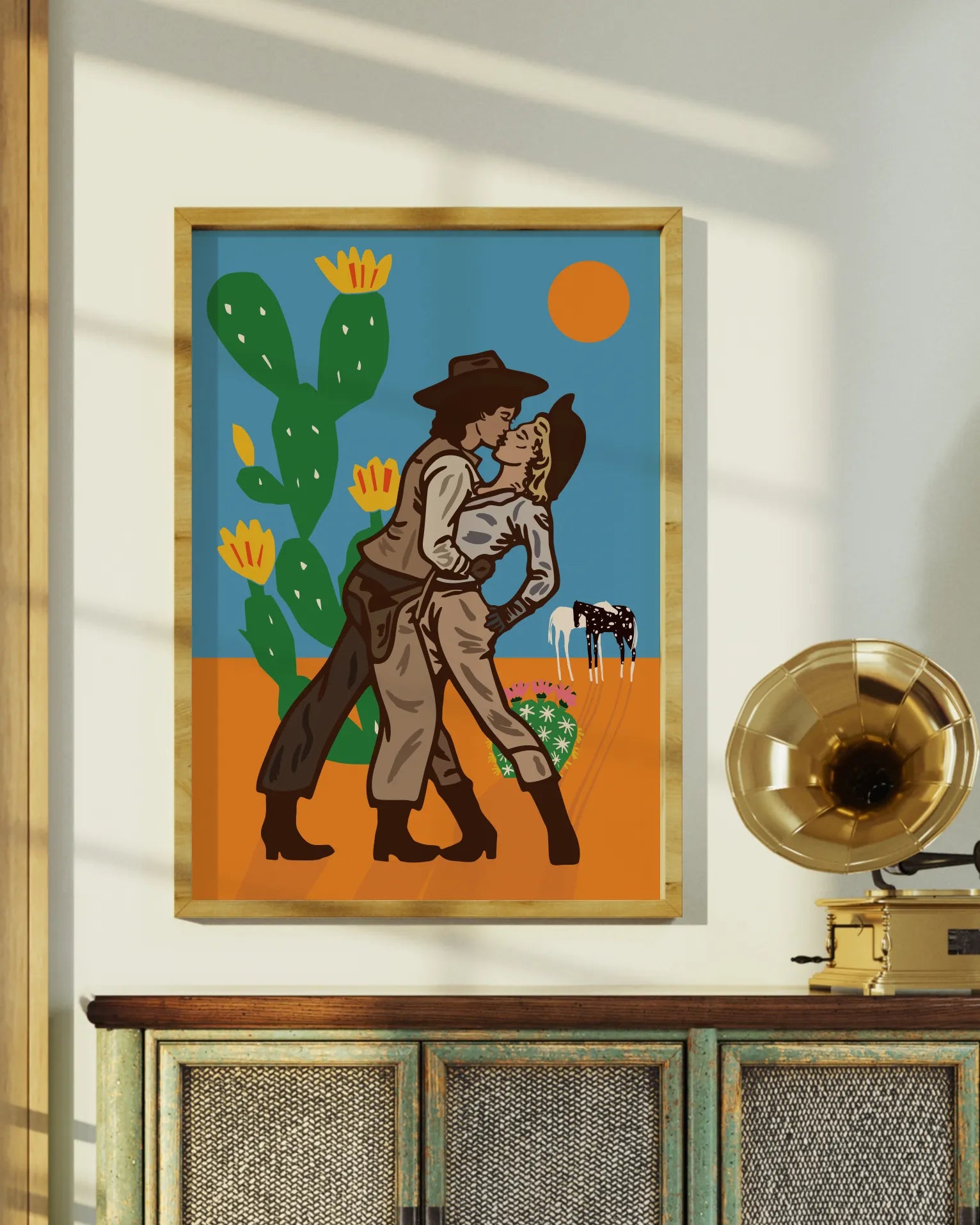 An illustrated print with a lesbian cowgirl couple kissing in the desert.