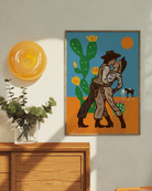 An illustrated print with a lesbian cowgirl couple kissing in the desert.