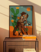 An illustrated print with a lesbian cowgirl couple kissing in the desert.