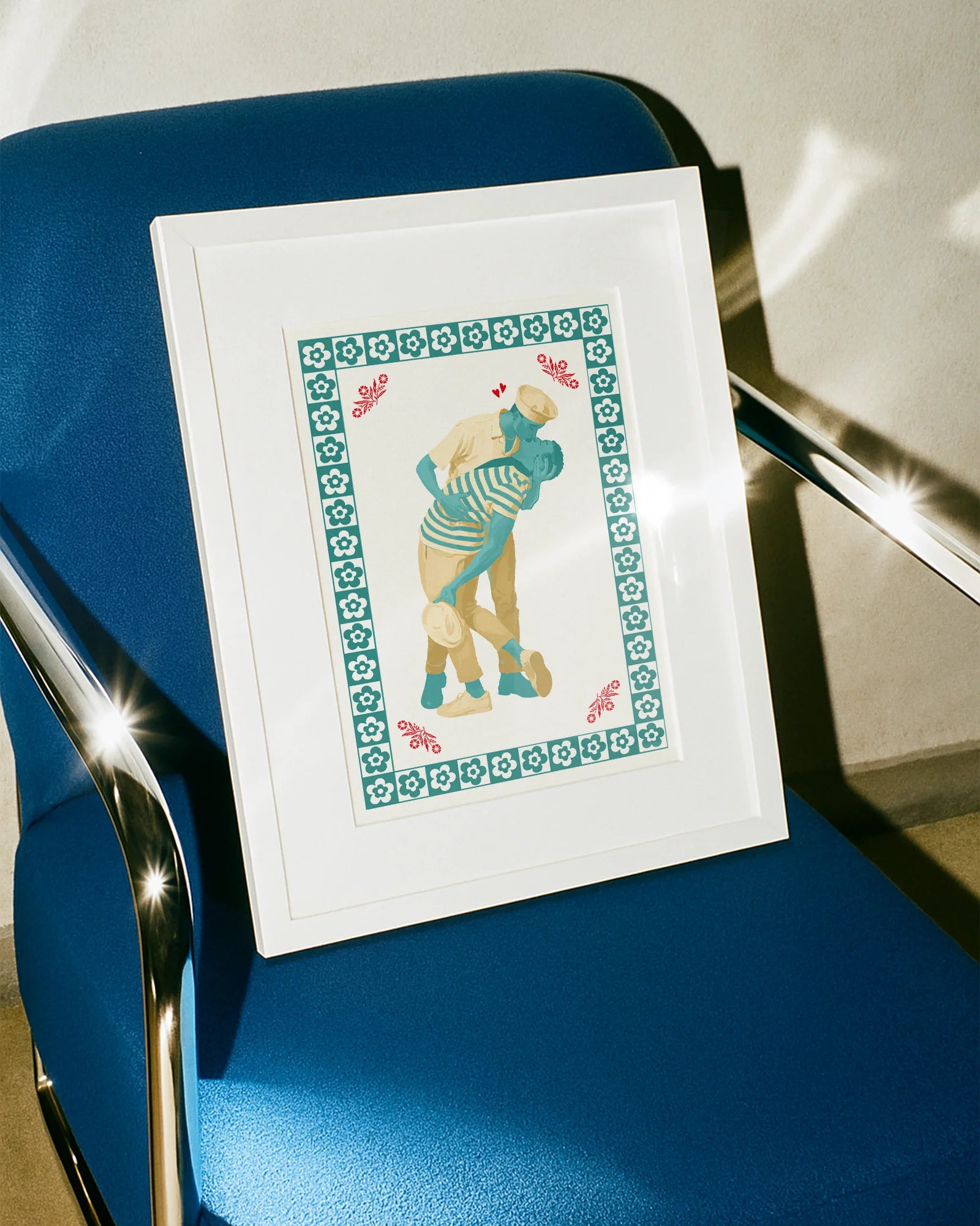 A poster featuring two gay sailor men locked in a passionate kiss, surrounded by a frame of soft flowers.