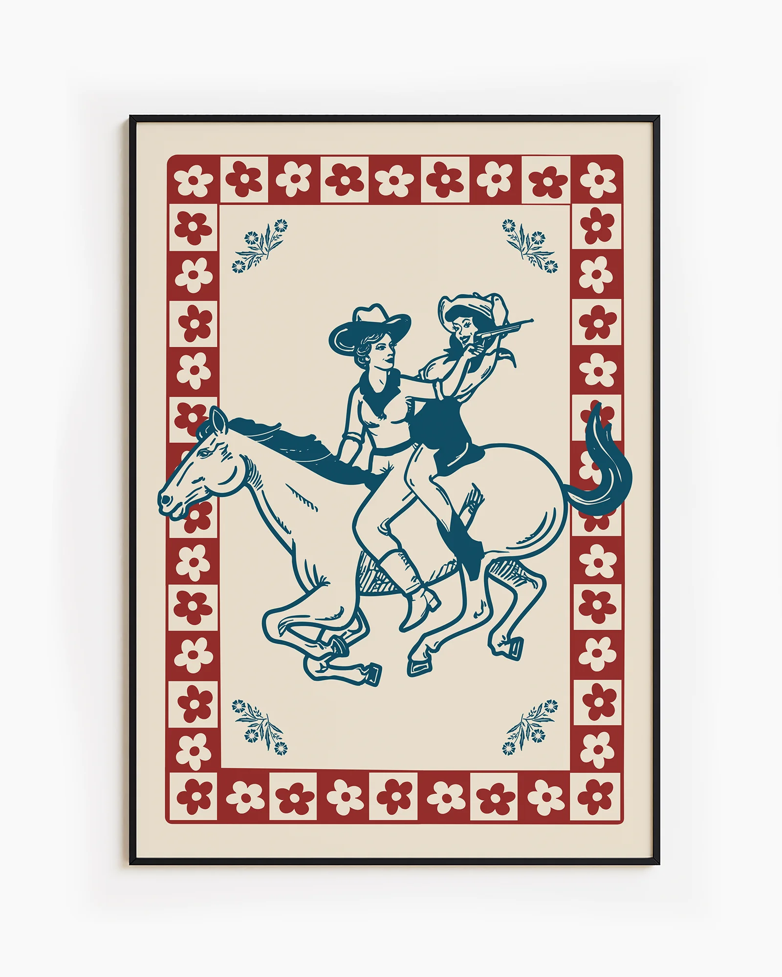 A framed poster featuring two cowgirls riding a horse, surrounded by a retro-style floral frame.