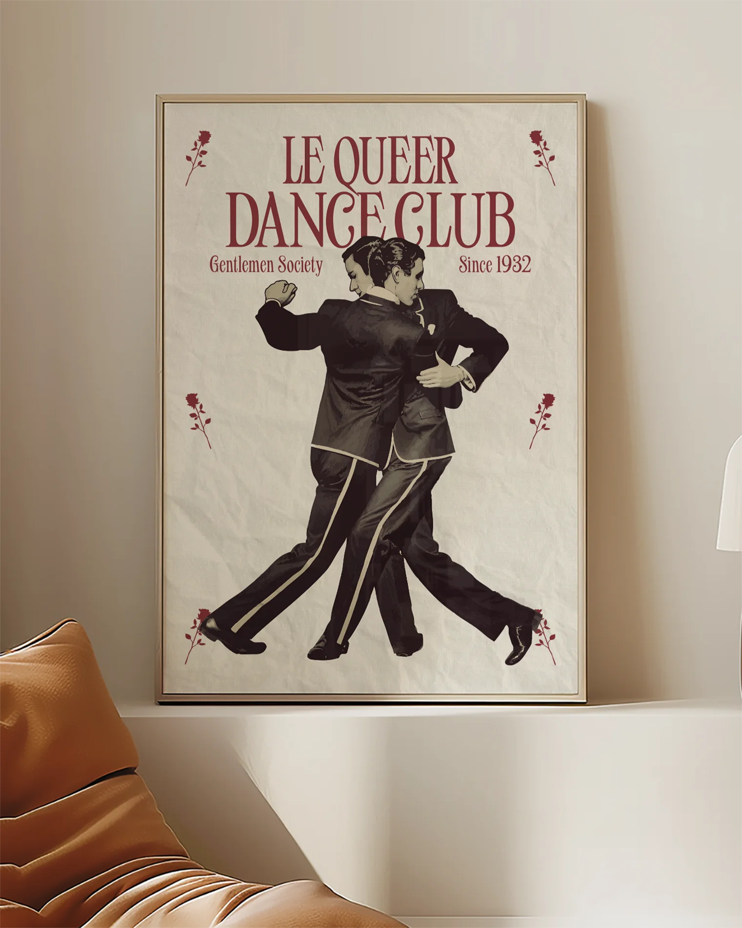 A framed print depicting two dancing gay men in a vintage, retro style, featuring the text “LE QUEER DANCECLUB” and “Gentlemen Society Since 1932.”