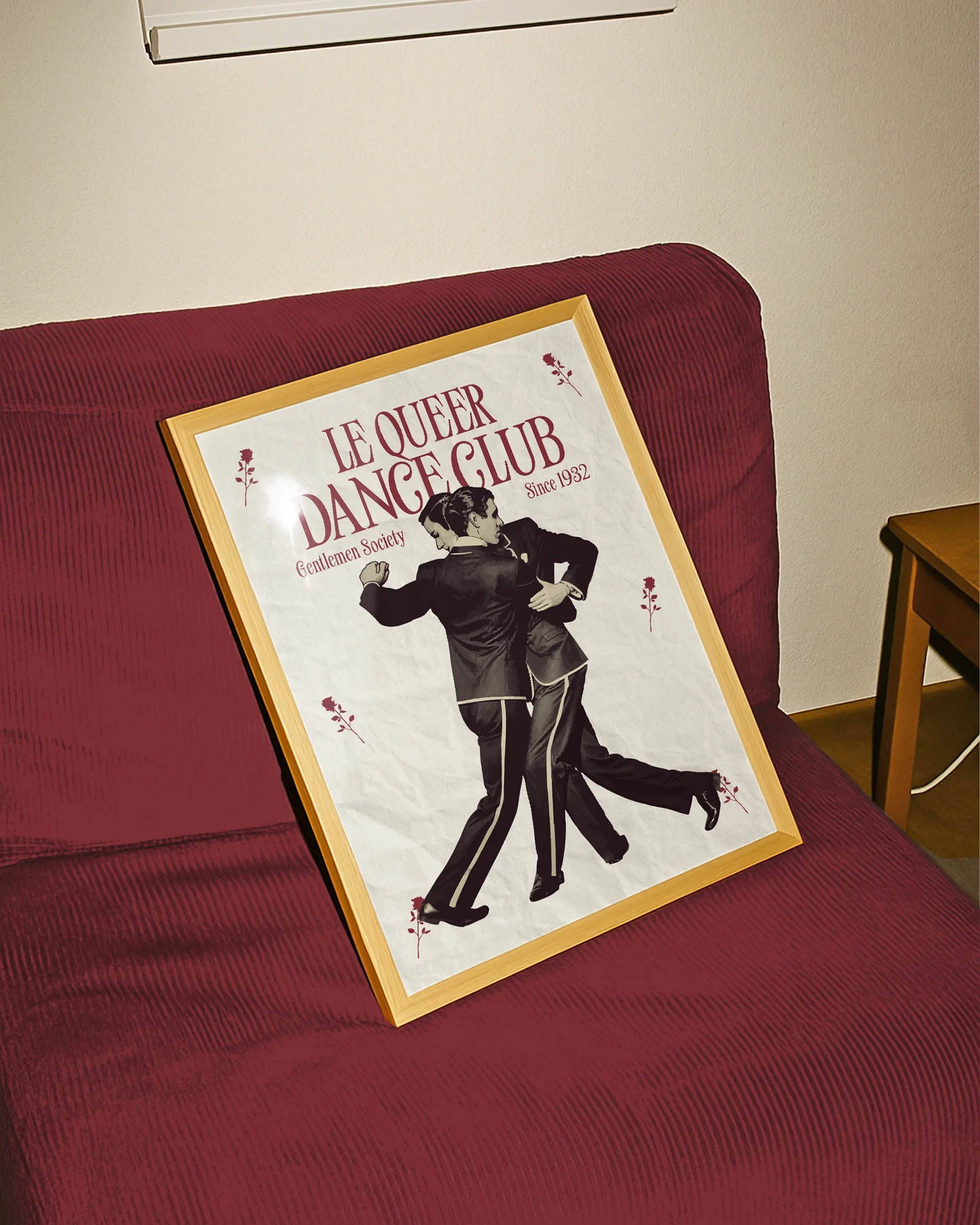 A framed print depicting two dancing gay men in a vintage, retro style, featuring the text “LE QUEER DANCECLUB” and “Gentlemen Society Since 1932.”