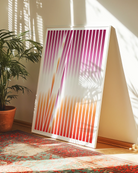 A framed poster with an abstract lesbian flag formed in stripes.