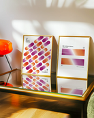 A print with rectangular, gradient shapes in a line, coloured with the lesbian pride flag colours, along the texts '005. The Gradient Collection' and 'Women Love Women'.