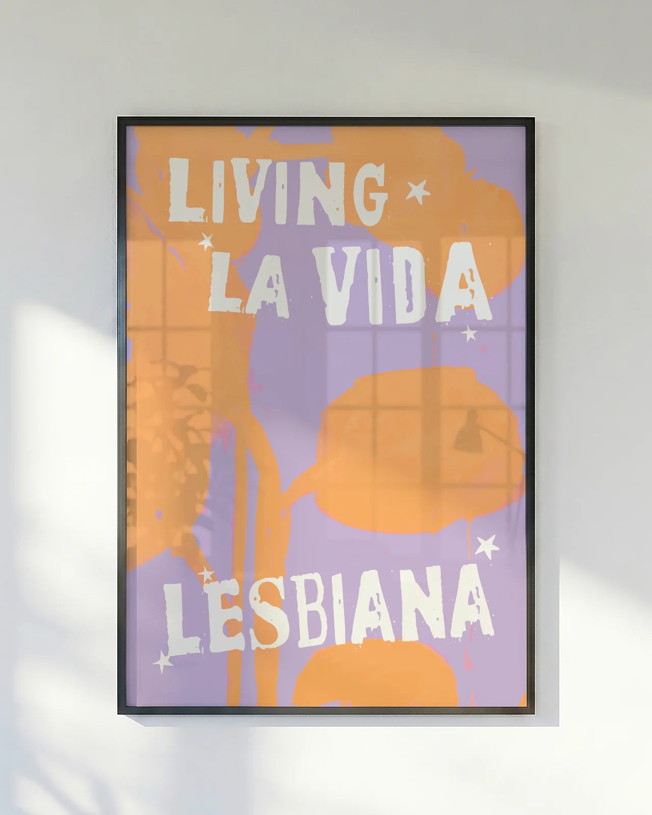 A poster with the text 'LIVING LA VIDA LESBIANA' against an abstract background.