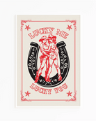 A print with an illustrated, lesbian cowgirls couple with the text 'Lucky me Lucky you.'