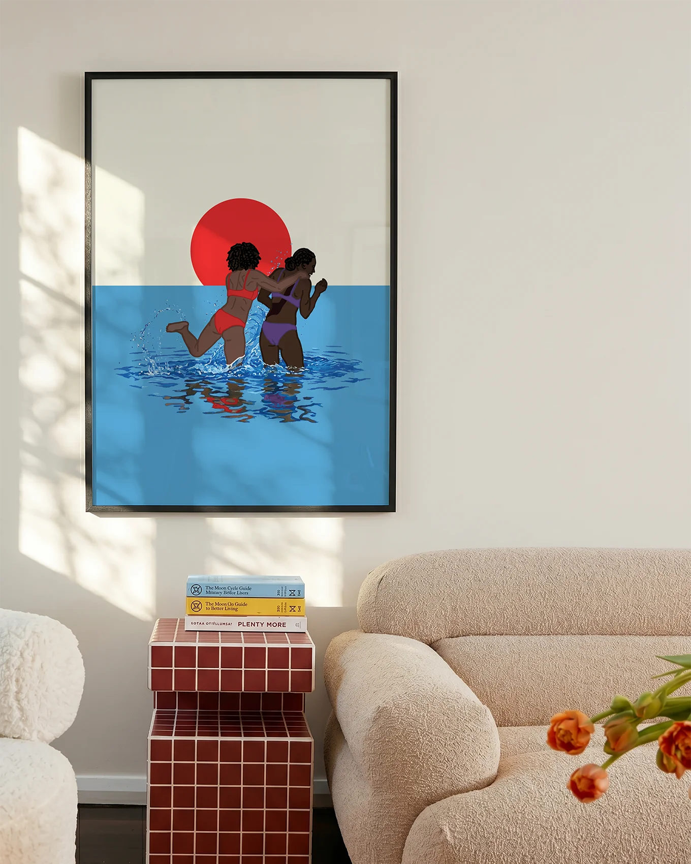 A poster with two lesbian girls playing in the ocean, in front of a sunset.