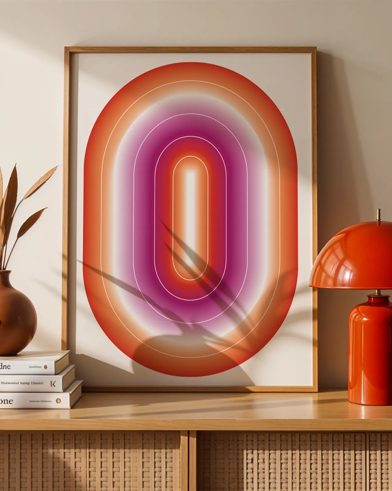 A framed print with a lesbian, illustrative flag in an oval form.