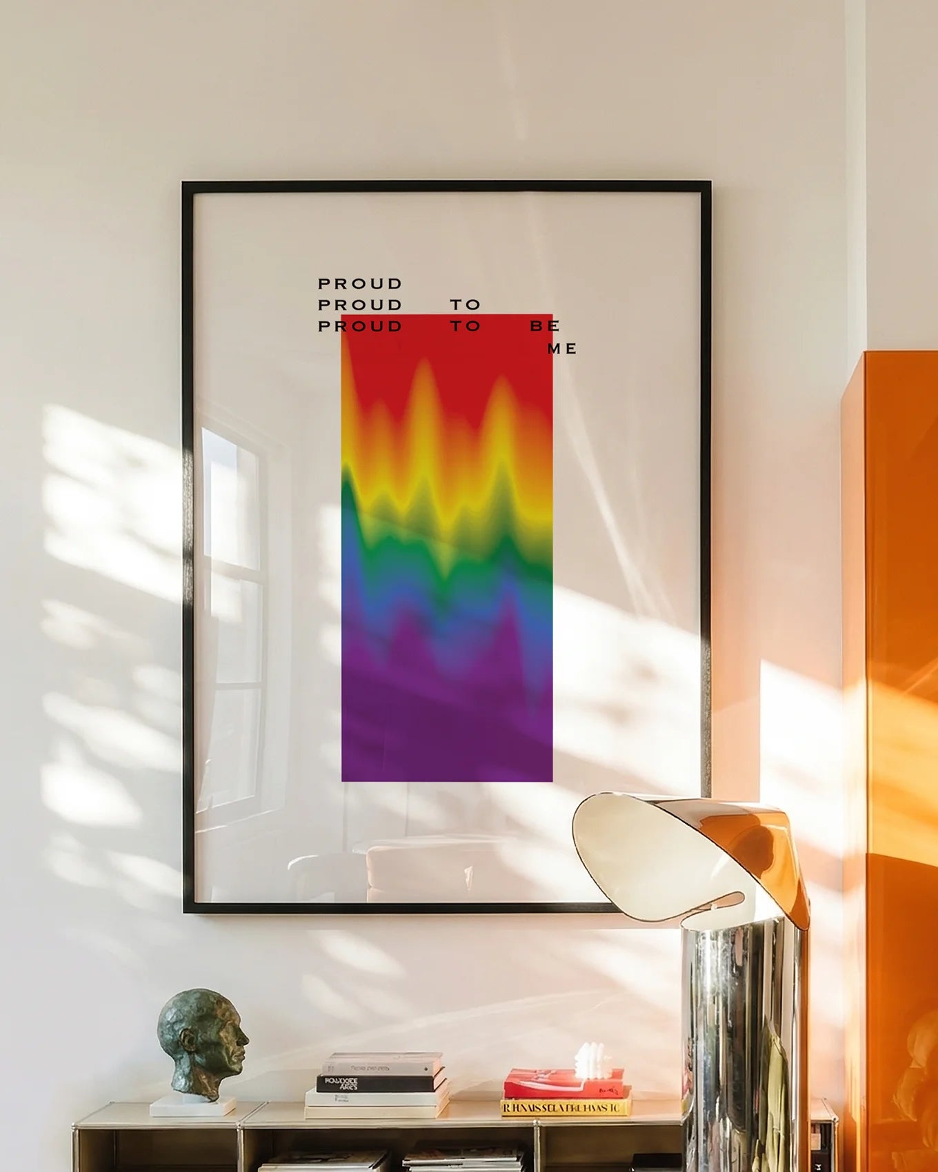 A poster with a gradient pride flag and the text: 'Proud to be me'.