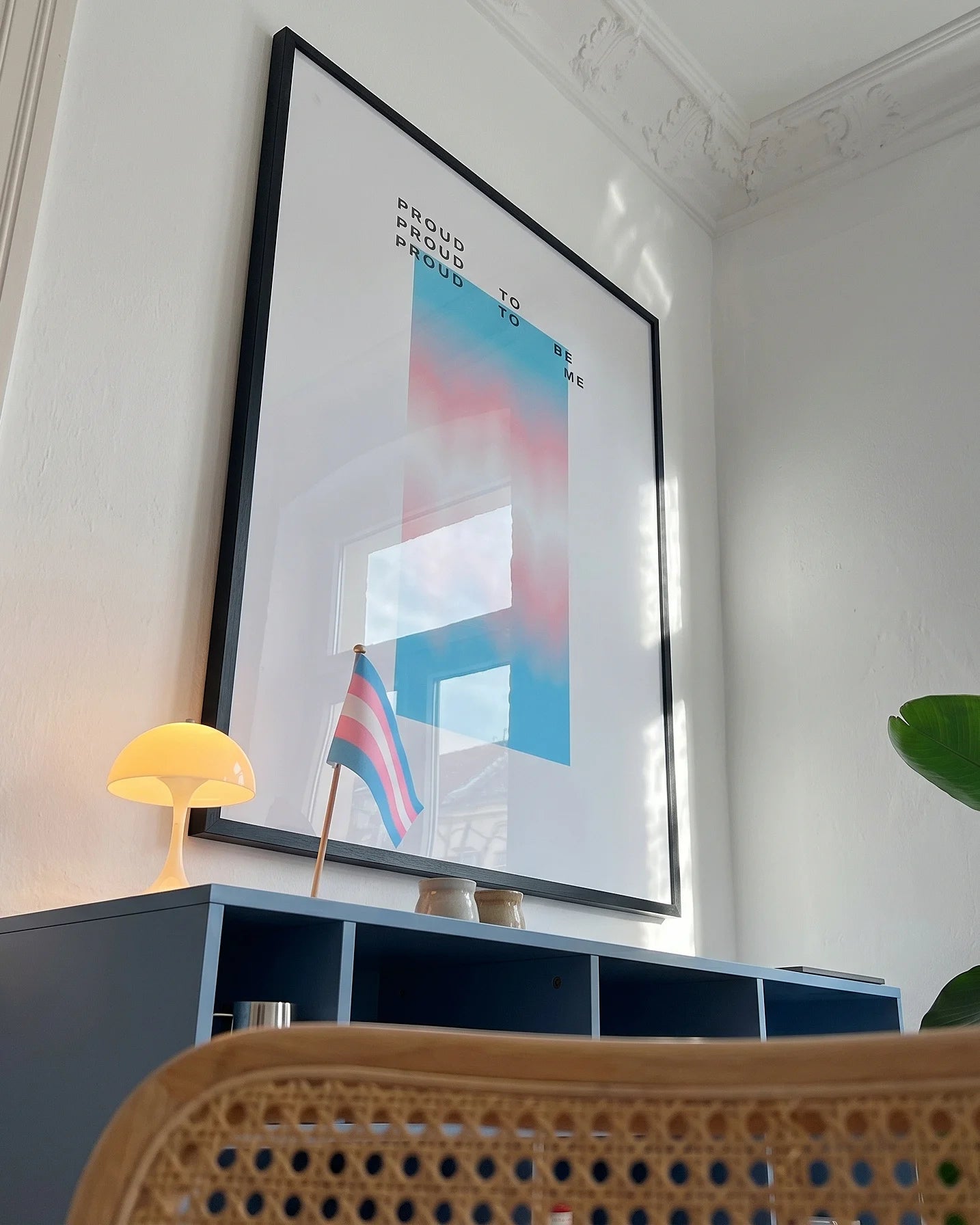 A poster with a gradient transgender pride flag and the text: 'Proud to be me'.