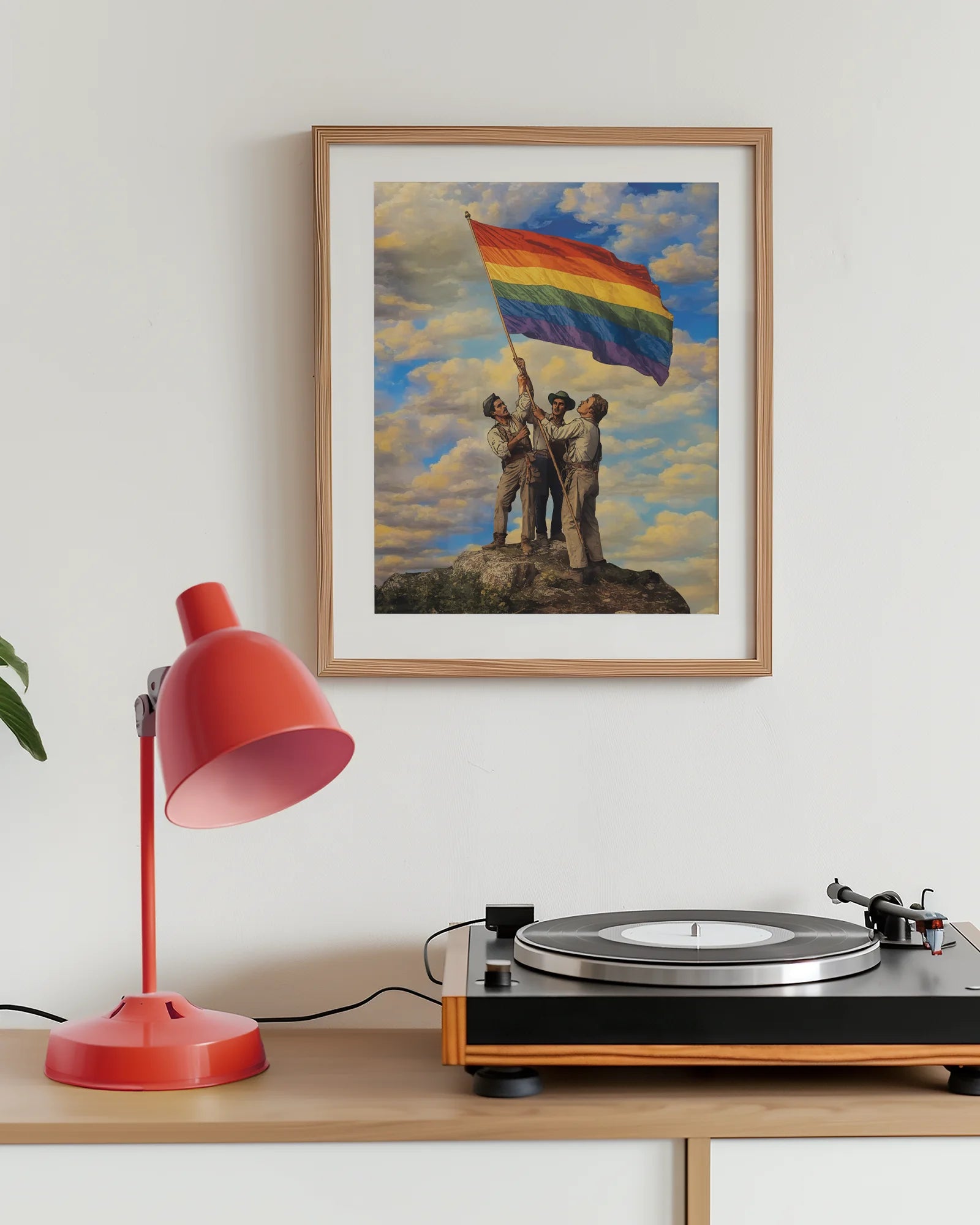 A framed poster with three gay men raising a Pride flag together, symbolizing unity, courage, and the ongoing fight for LGBTQIA+ rights.