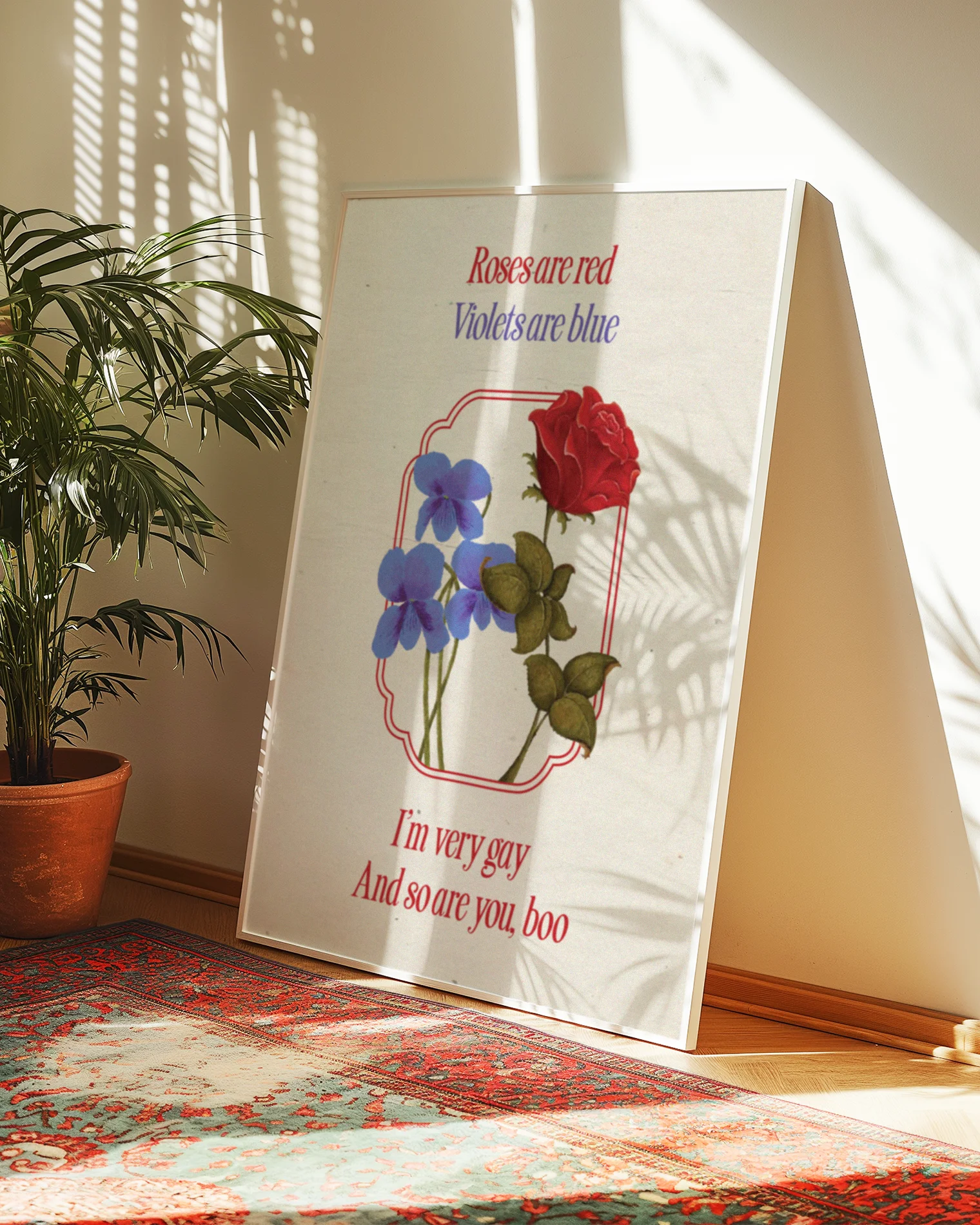 A framed poster featuring violets and red roses with the text:
"Roses are red, Violets are blue. I'm very gay, And so are you, boo."