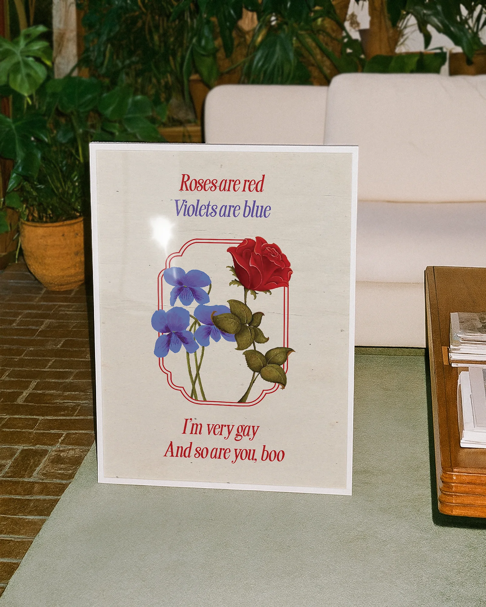 A framed poster featuring violets and red roses with the text:
"Roses are red, Violets are blue. I'm very gay, And so are you, boo."