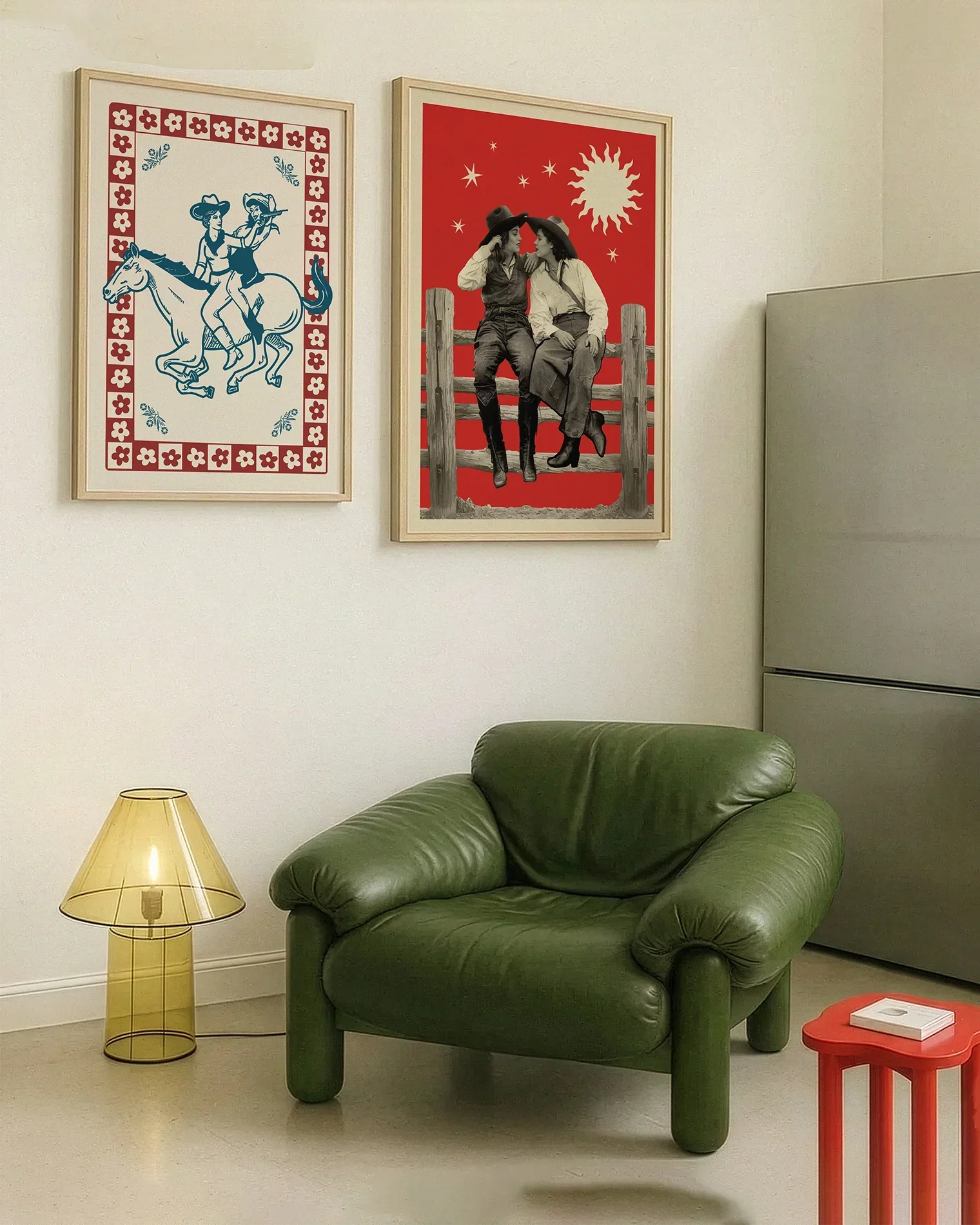 A gallery wall with several framed, queer posters in a living room.