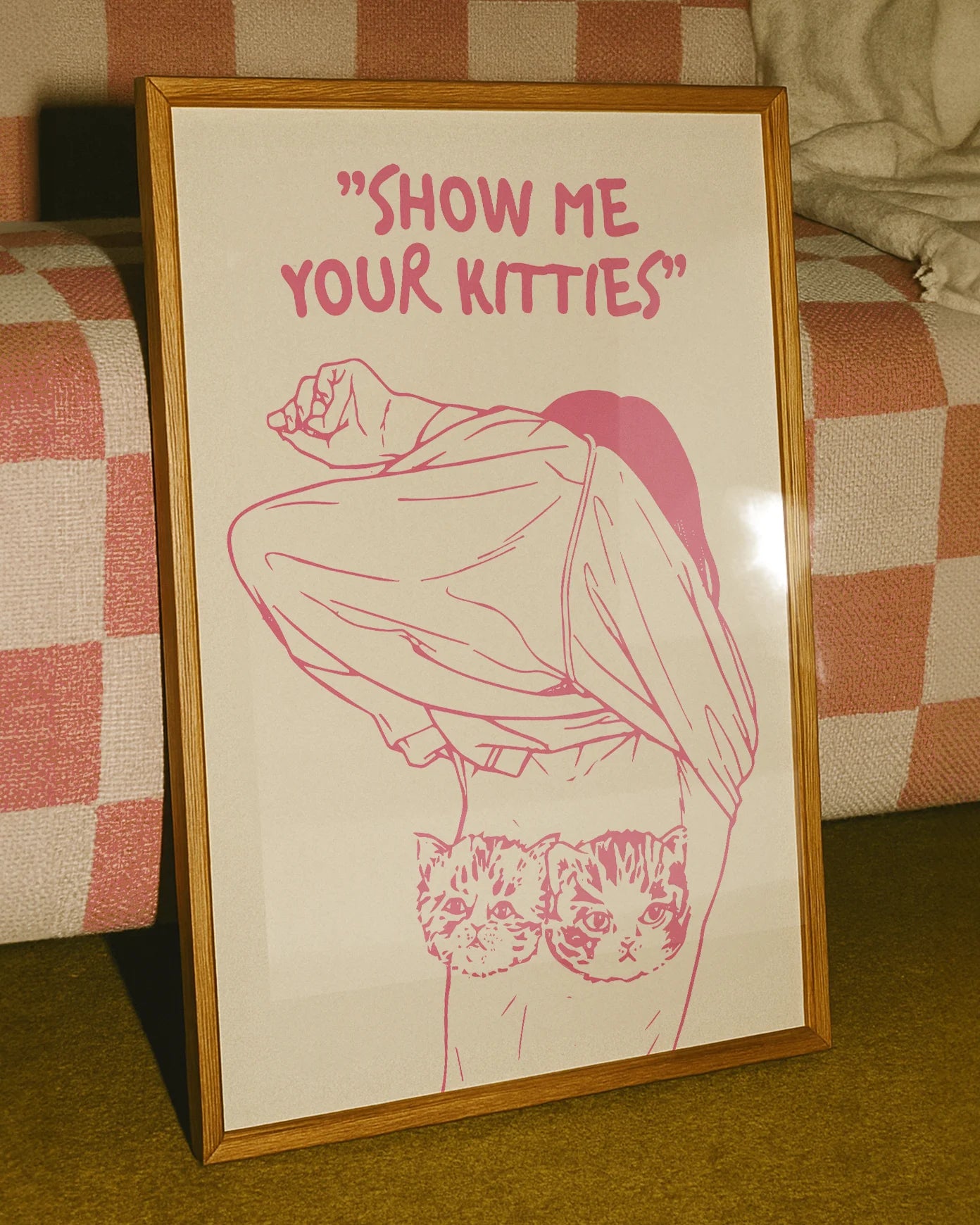 A poster of a woman removing her shirt with the text "SHOW ME YOUR KITTIES".