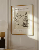 The poster features two women fencing, with the text: “SLAYING THE PATRIARCHY SINCE 1884.”