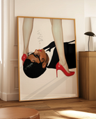 A poster featuring a woman in a blazer, lying on the floor with a cigarette in her mouth, gazing up at another woman standing over her in red heels.