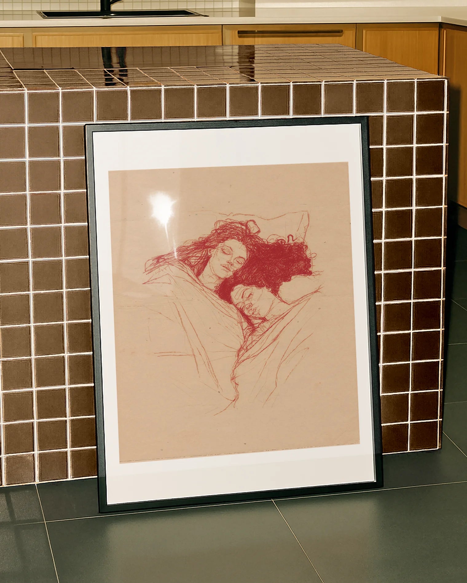 A framed poster with a lesbian couple sleeping under a blanket, sketch style.