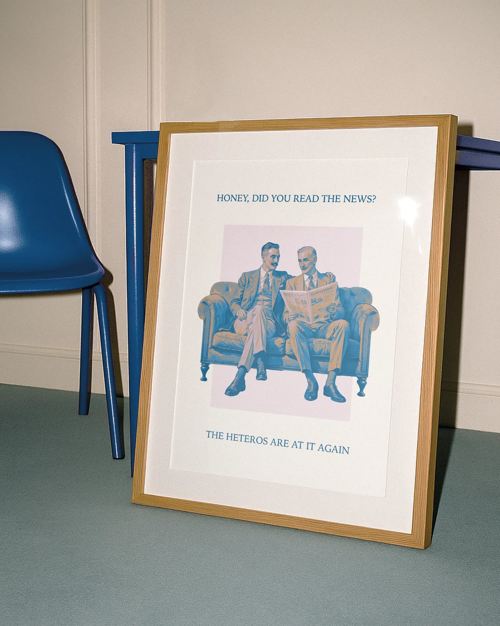 A poster with an older, stylish gay couple in suits, sitting on a couch reading the morning paper together with the text:
“Honey, did you read the news? The heteros are at it again.”