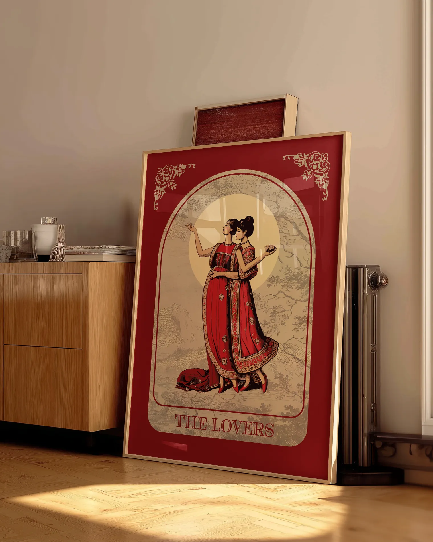 A poster with an illustrated, sapphic couple in the 1700's, posing in red dresses with the text 'The Lovers'.