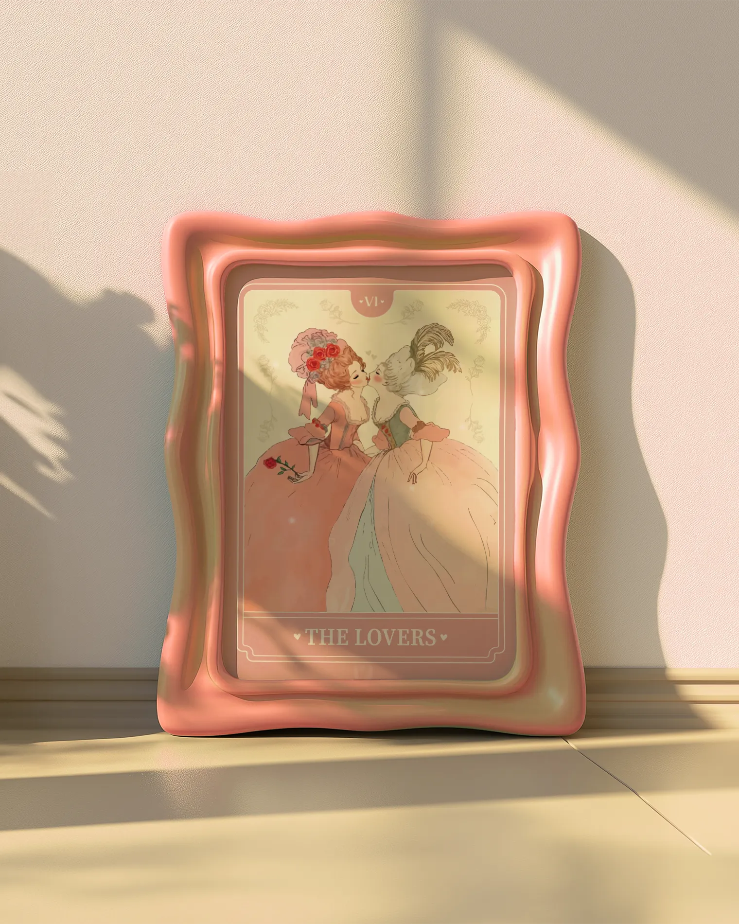 A print with a sapphic couple kissing in a tarot-style, 1700's era, with the text 'The Lovers'.