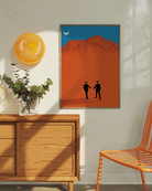 A framed print with a couple in suits, walking hand in hand in a desert.