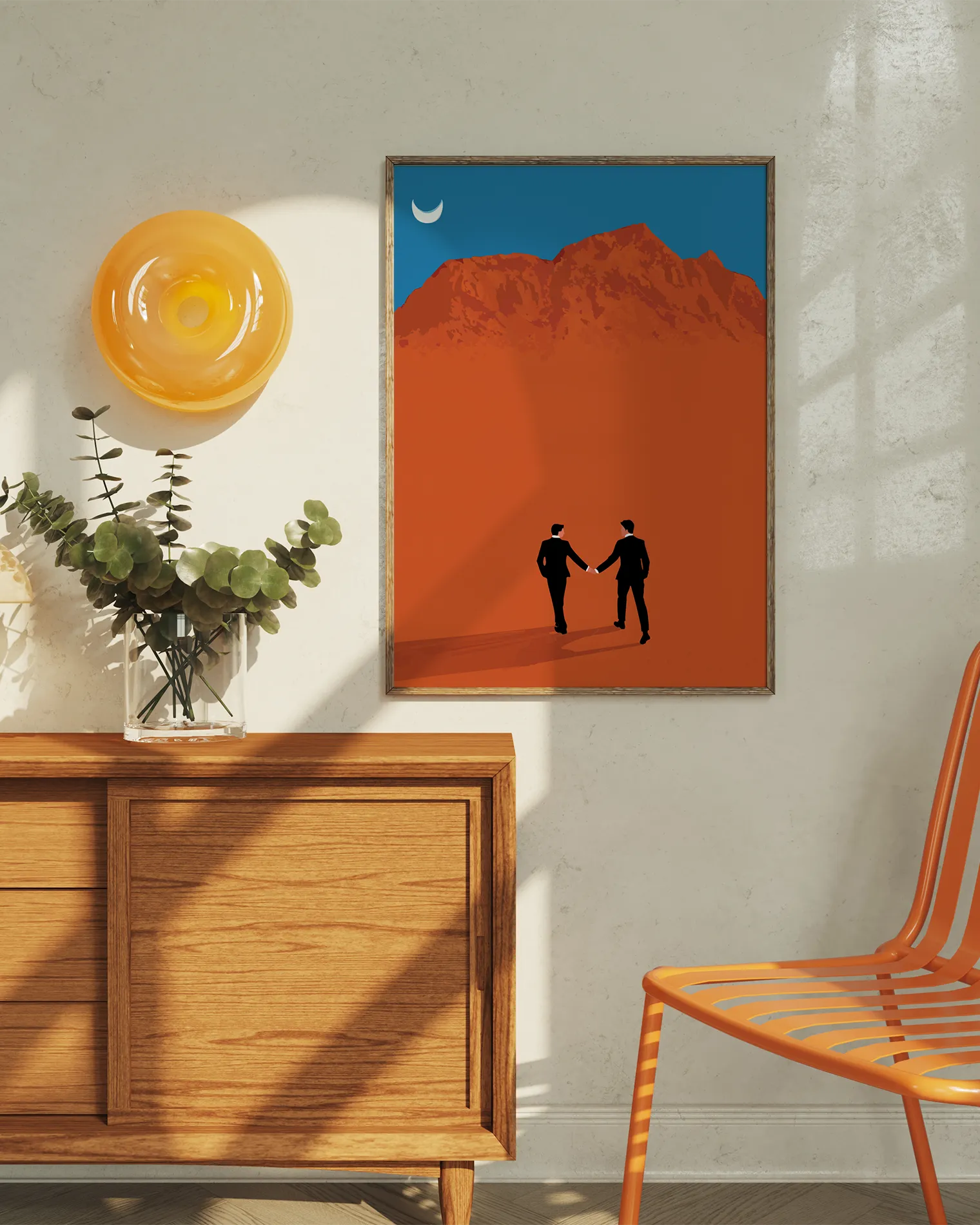 A framed print with a couple in suits, walking hand in hand in a desert.