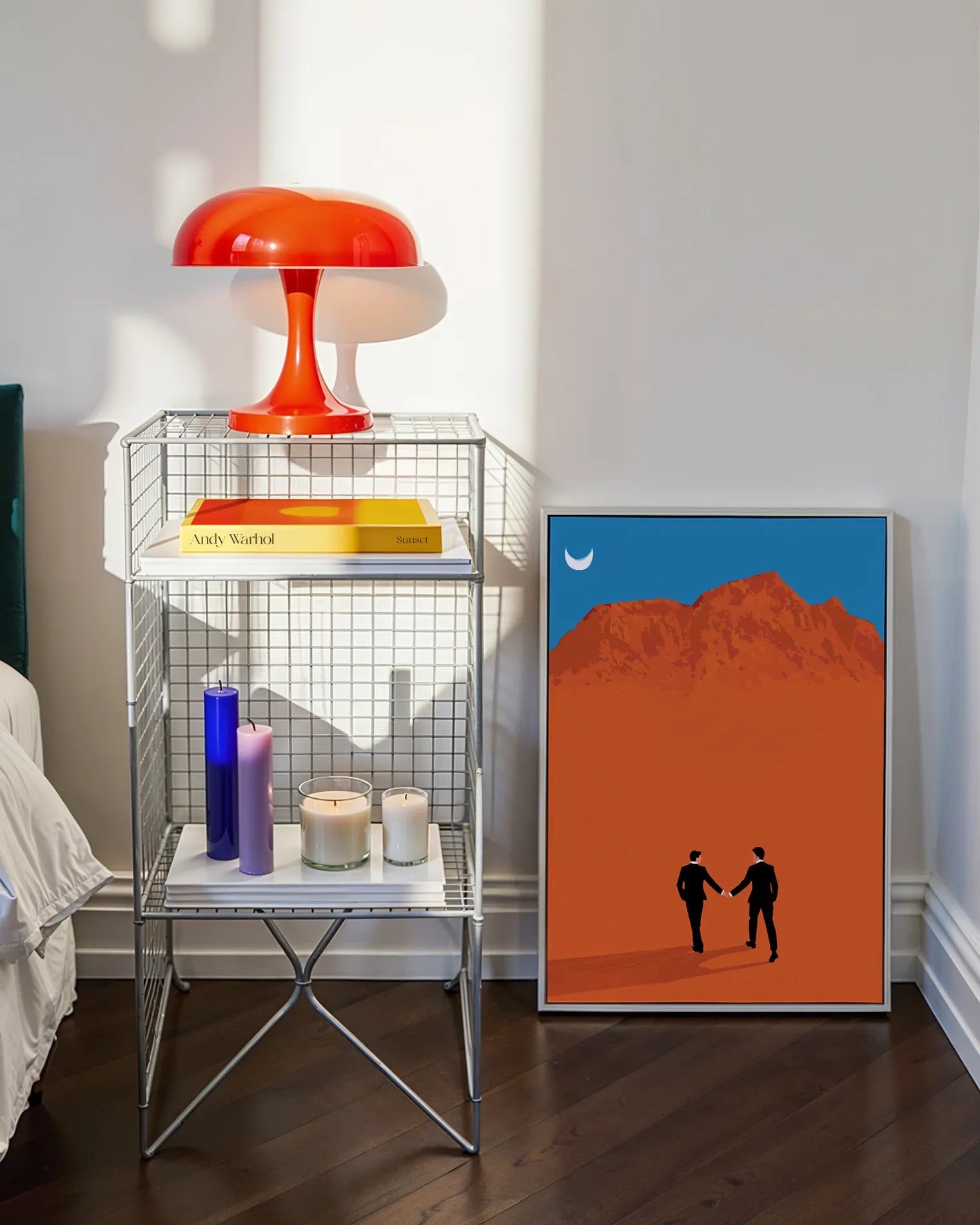 A framed print with a couple in suits, walking hand in hand in a desert.