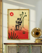A print with an illustrated cowboys-couple in a desert, surrounded by a red and yellow sunset.