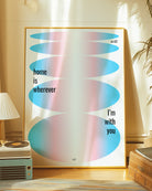 A retro inspired poster with oval forms in trans colours and text 'home is wherever I'm with you'.