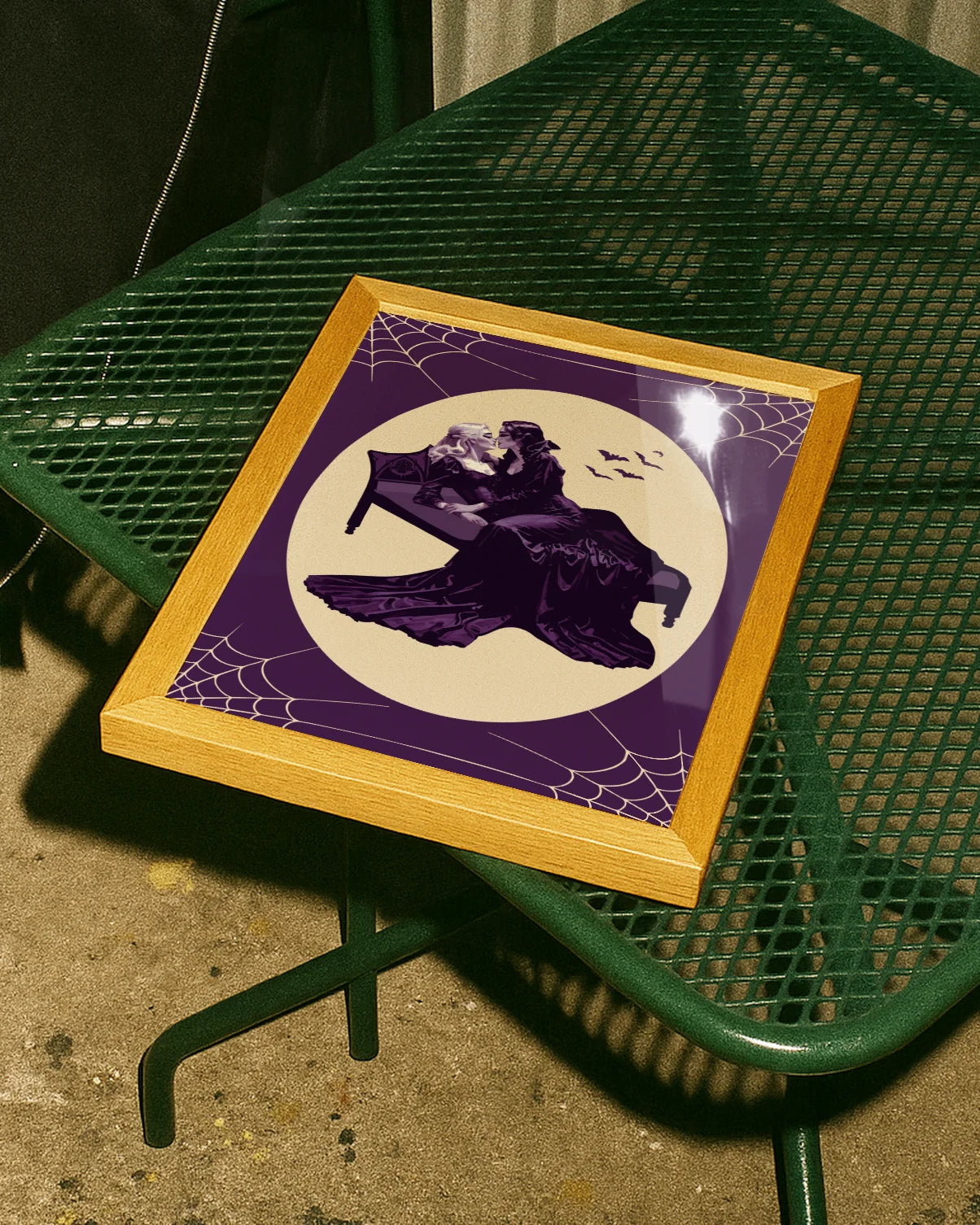 A poster with a lesbian vampire couple kissing in a bed.