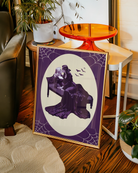 A poster with a lesbian vampire couple kissing in a bed.