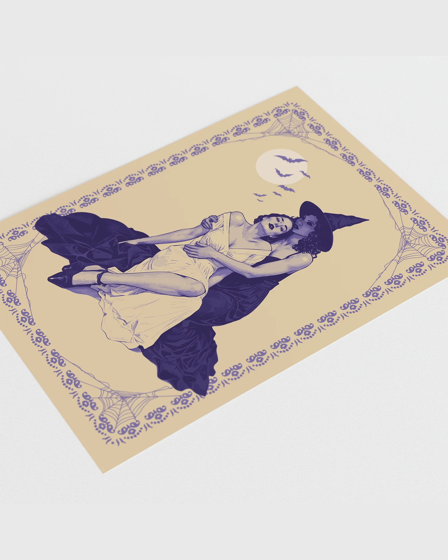 A poster with a witch tenderly holding her lover, surrounded by a spiderweb-infused frame and a large white full moon with flying bats in the background.