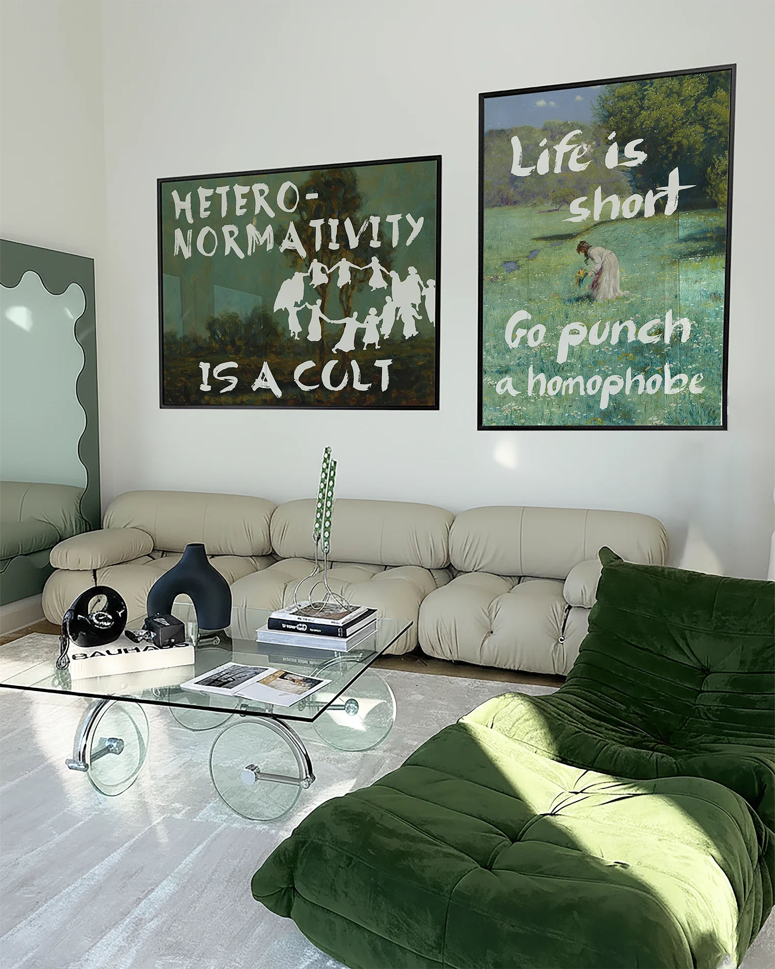 Two framed queer, statement prints on a wall.